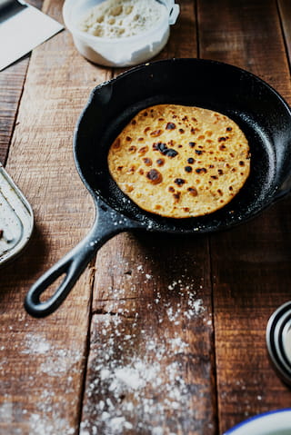 Naan bread in a frying pan