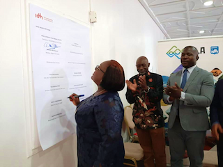 Minister Anne Ouloto signing Letter of Intent 20 Feb 2020 in Cote dIvoire